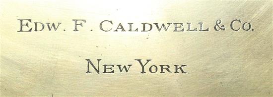 An early 20th century gilt and ebonised octagonal cased mantel clock retailed by Edward F. Caldwell & Co, New York, 13.75in.